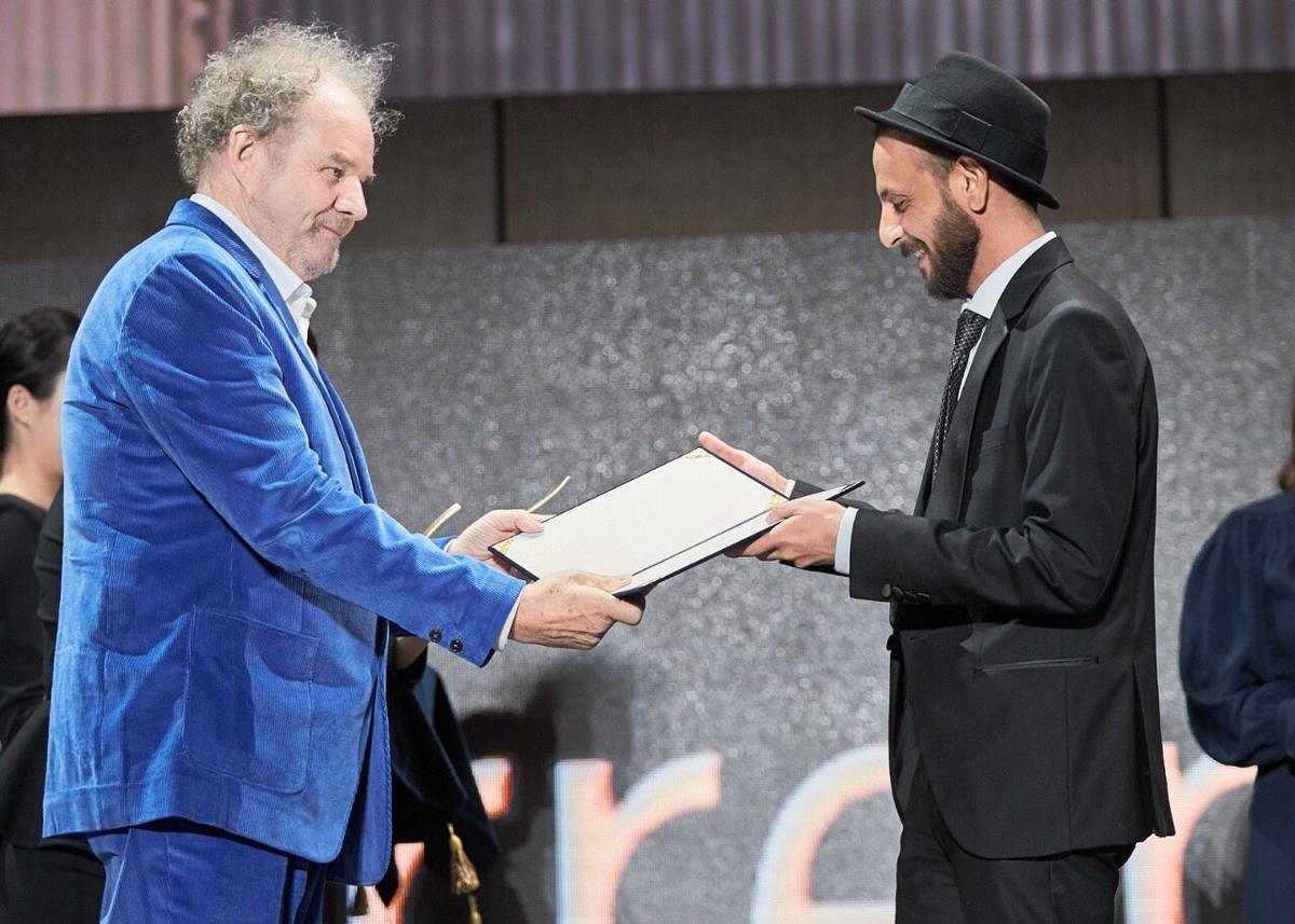 Busan International Film Festival, 2019 — receiving the New Currents Award from jury president Mike Figgis